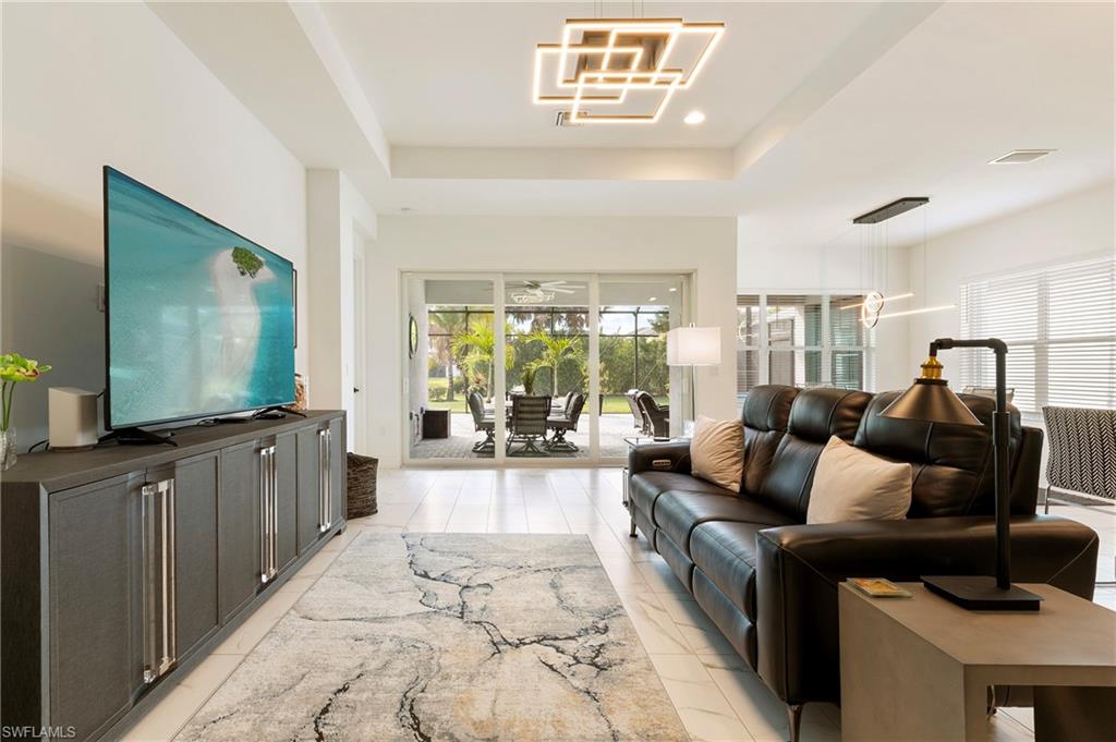 11488 Coronado Way Naples, FL 34120 - Photo 5 of 50 a living room with furniture and a flat screen tv