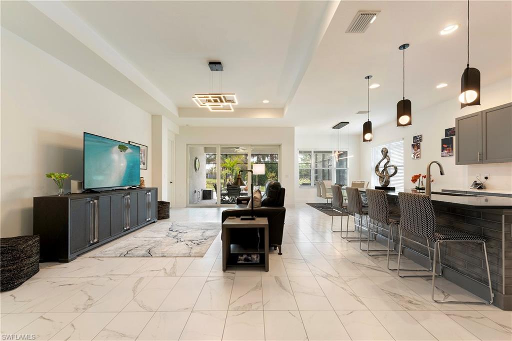11488 Coronado Way Naples, FL 34120 - Photo 9 of 50 a living room with furniture and a flat screen tv