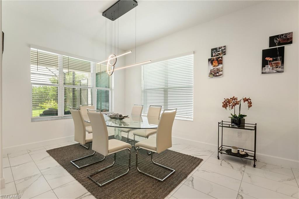 11488 Coronado Way Naples, FL 34120 - Photo 10 of 50 a view of a dining room with furniture and window