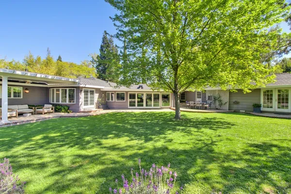 a front view of a house with a garden