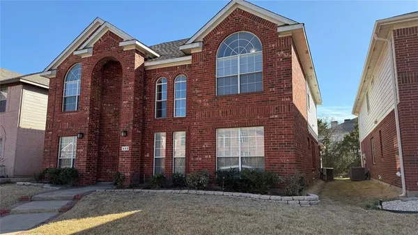 a view of a brick house with large windows