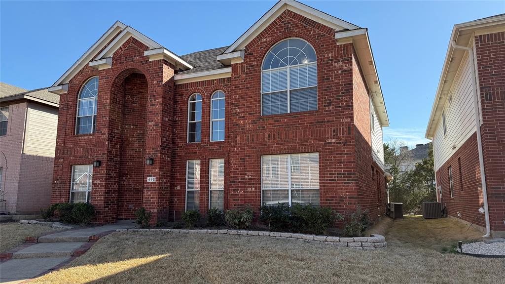 442 Spring Air Drive Allen, TX 75002 - Photo 2 of 27 a view of a brick house with large windows