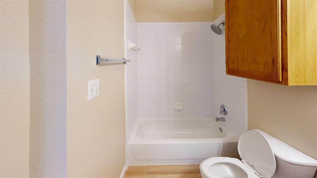 442 Spring Air Drive Allen, TX 75002 - Photo 22 of 27 a bathroom with a toilet tub sitting next to a window