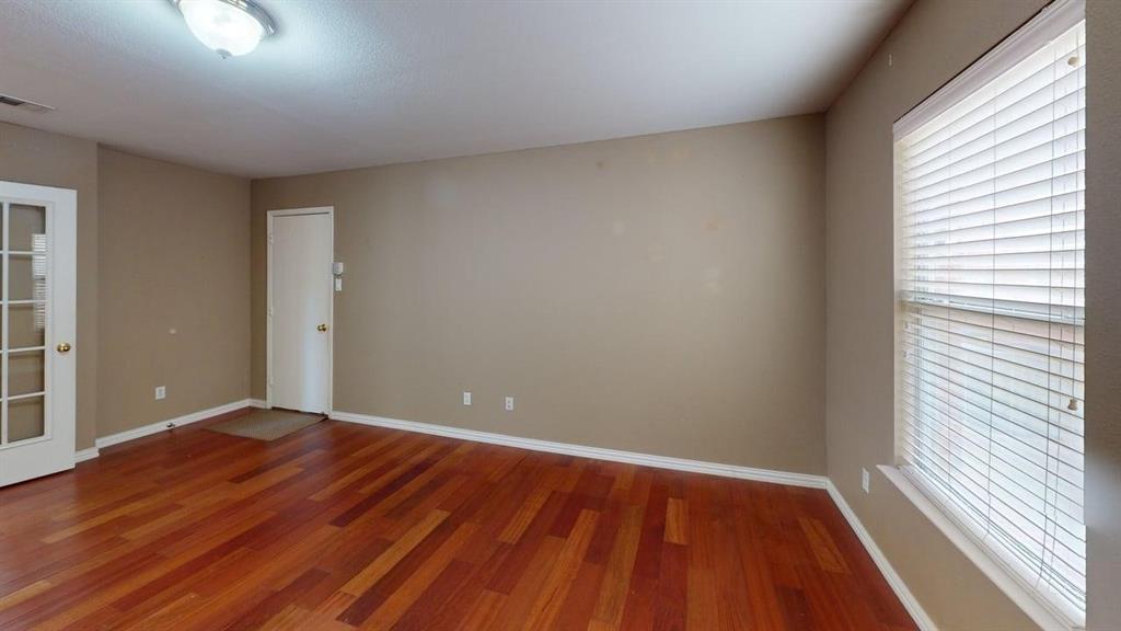 442 Spring Air Drive Allen, TX 75002 - Photo 7 of 27 a view of an empty room with wooden floor and a window