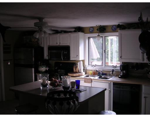 25 Wallace Road Sturbridge, MA 01566 - Photo 3 of 5 a kitchen with a sink stove and cabinets