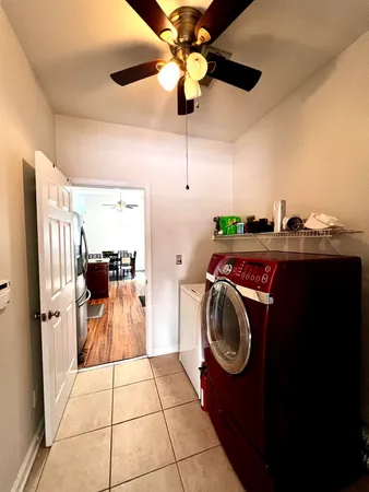 a utility room with closet and racks
