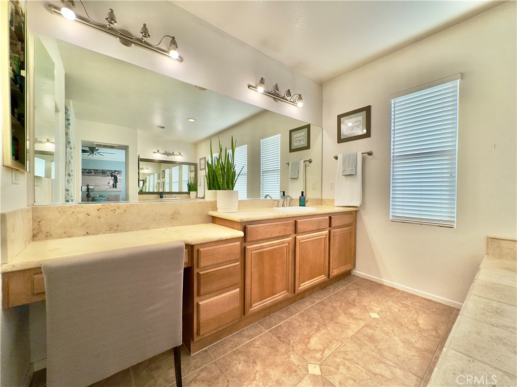 11265 Runyan Road Beaumont, CA 92223 - Photo 83 of 138 a spacious bathroom with a granite countertop sink and a mirror