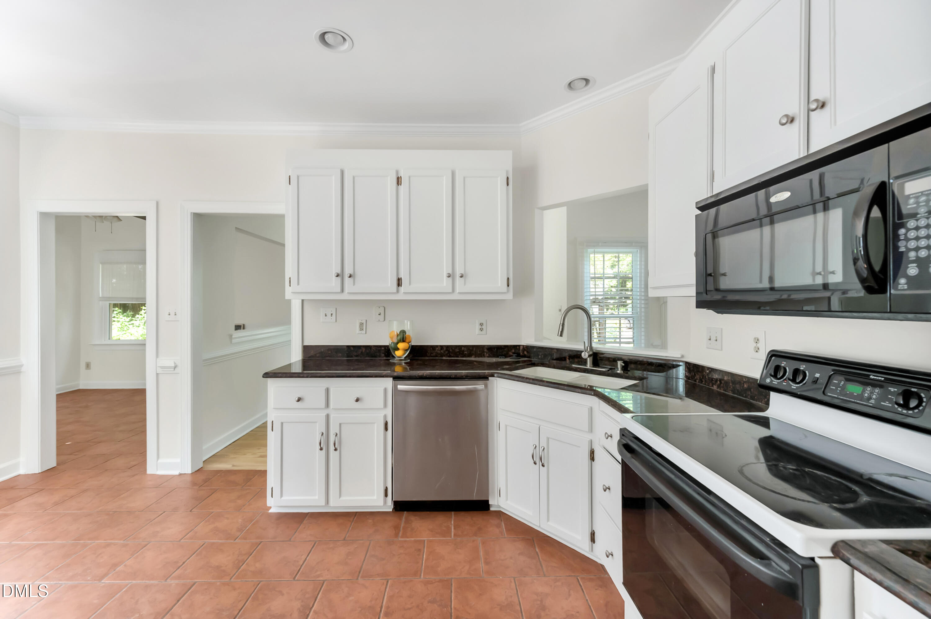 7500 Drayton Court Raleigh, NC 27615 - Photo 6 of 27 a kitchen with granite countertop a stove sink and cabinets