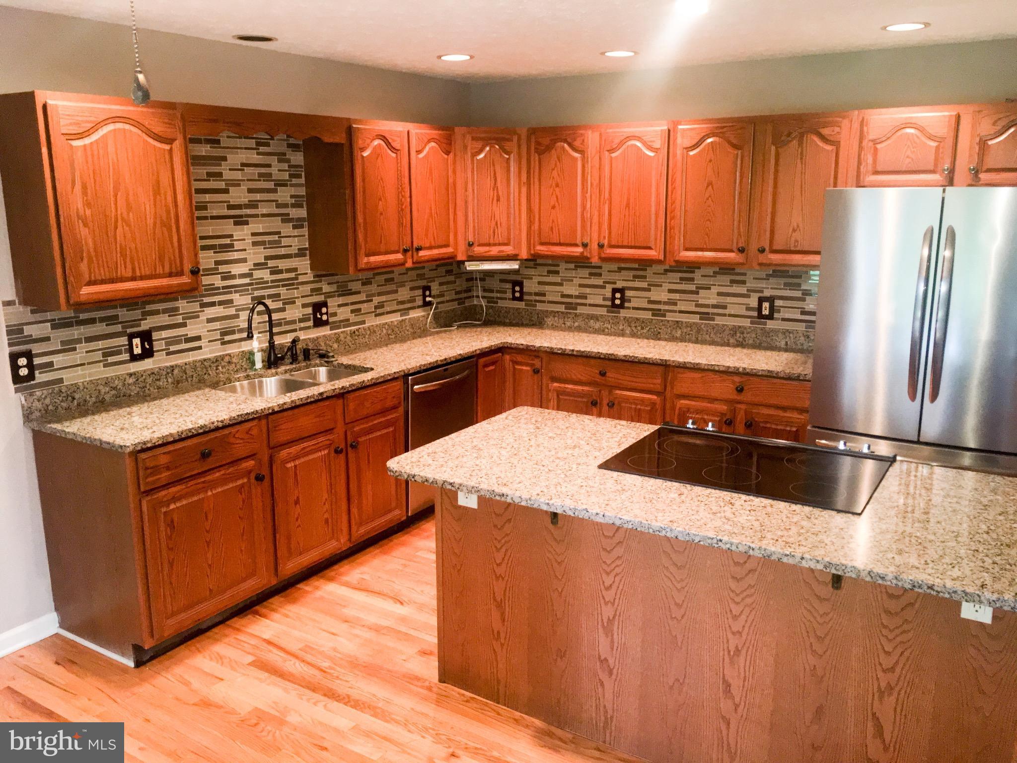 127 Holiday Road Cross Junction, VA 22625 - Photo 11 of 29 a kitchen with stainless steel appliances a sink stove and refrigerator