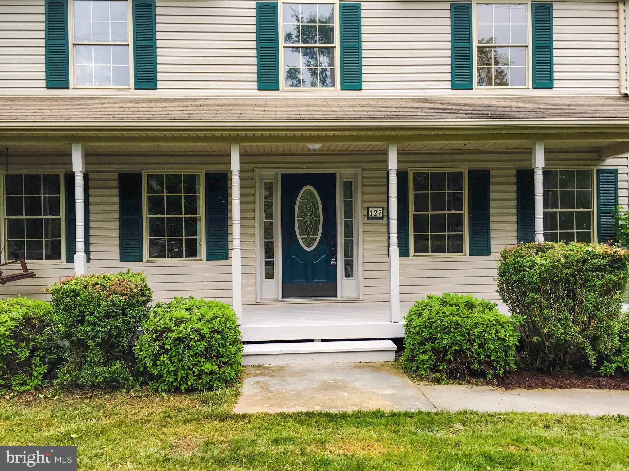 127 Holiday Road Cross Junction, VA 22625 - Photo 3 of 29 front view of a brick house with a large window and a yard