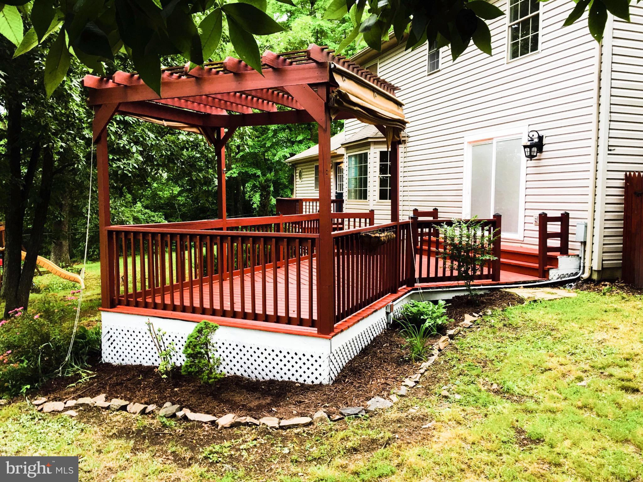 127 Holiday Road Cross Junction, VA 22625 - Photo 7 of 29 a view of a patio with a table chairs and a yard