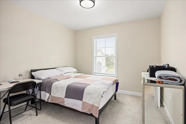 a bedroom with a bed and a chair