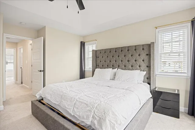 a bedroom with a bed and a ceiling fan