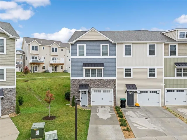 an aerial view of residential houses with outdoor space