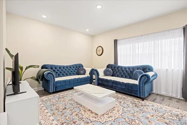 a living room with a couch and a dresser