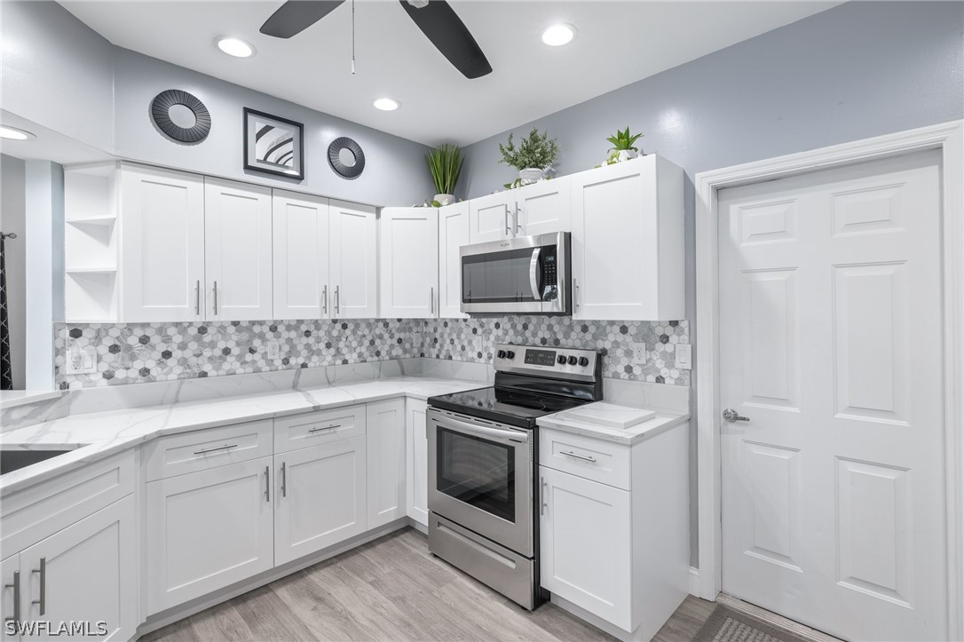 637 Windsor Square, Unit 102 Naples, FL 34104 - Photo 11 of 36 a kitchen with stainless steel appliances white cabinets and a sink