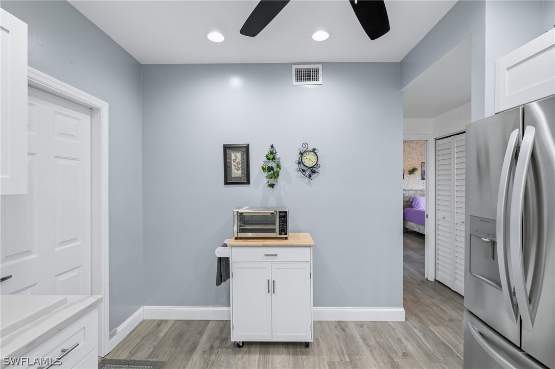 637 Windsor Square, Unit 102 Naples, FL 34104 - Photo 12 of 36 a room with furniture and wooden floor