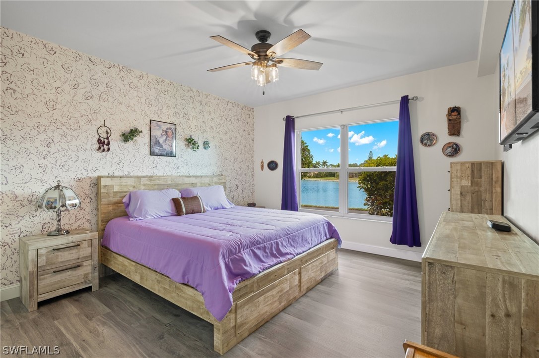 637 Windsor Square, Unit 102 Naples, FL 34104 - Photo 13 of 36 a bedroom with a bed and window