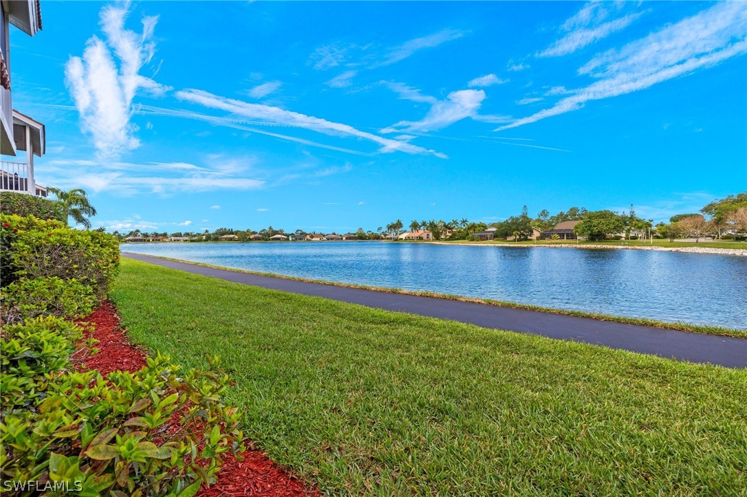 637 Windsor Square, Unit 102 Naples, FL 34104 - Photo 22 of 36 a view of a lake with houses in the back