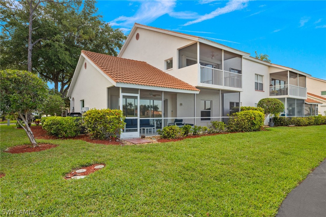 637 Windsor Square, Unit 102 Naples, FL 34104 - Photo 23 of 36 a front view of a house with a yard