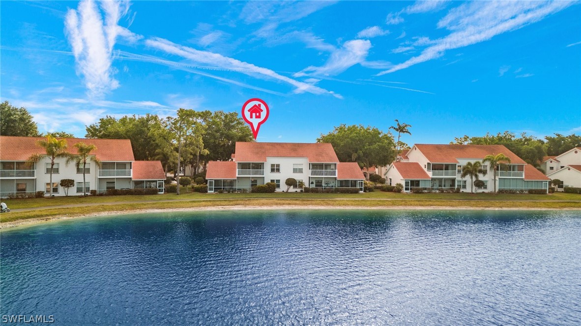 637 Windsor Square, Unit 102 Naples, FL 34104 - Photo 27 of 36 a view of an swimming pool with a lawn chairs and a big yard
