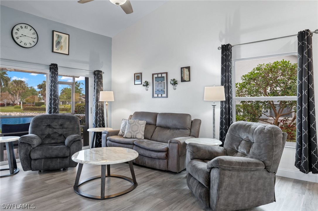 637 Windsor Square, Unit 102 Naples, FL 34104 - Photo 4 of 36 a living room with furniture and a large window