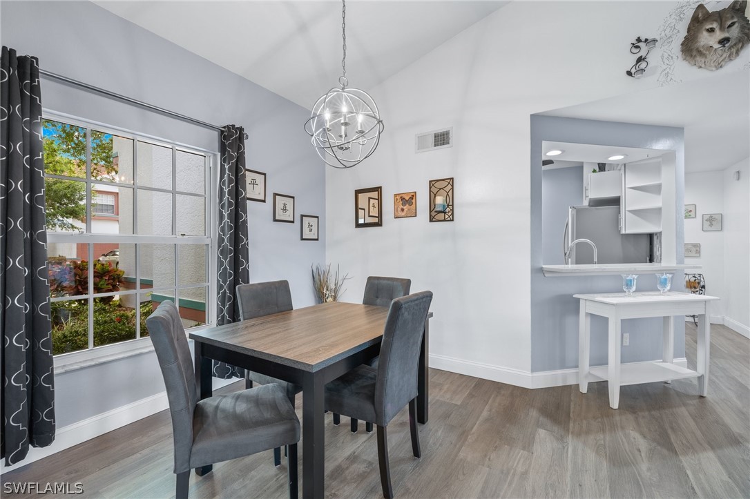 637 Windsor Square, Unit 102 Naples, FL 34104 - Photo 8 of 36 a view of a dining room with furniture window and wooden floor
