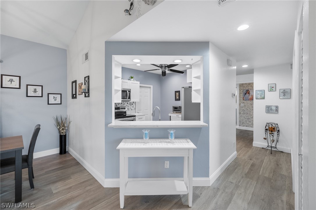 637 Windsor Square, Unit 102 Naples, FL 34104 - Photo 9 of 36 a view of a kitchen from the hallway