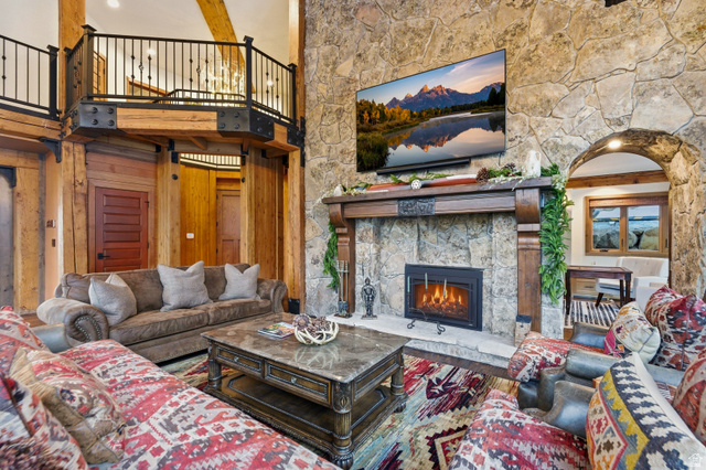 2687 Stewart Road Sundance, UT 84604 - Photo 3 of 48 Living room featuring a stone fireplace, wood finished floors, and wooden walls