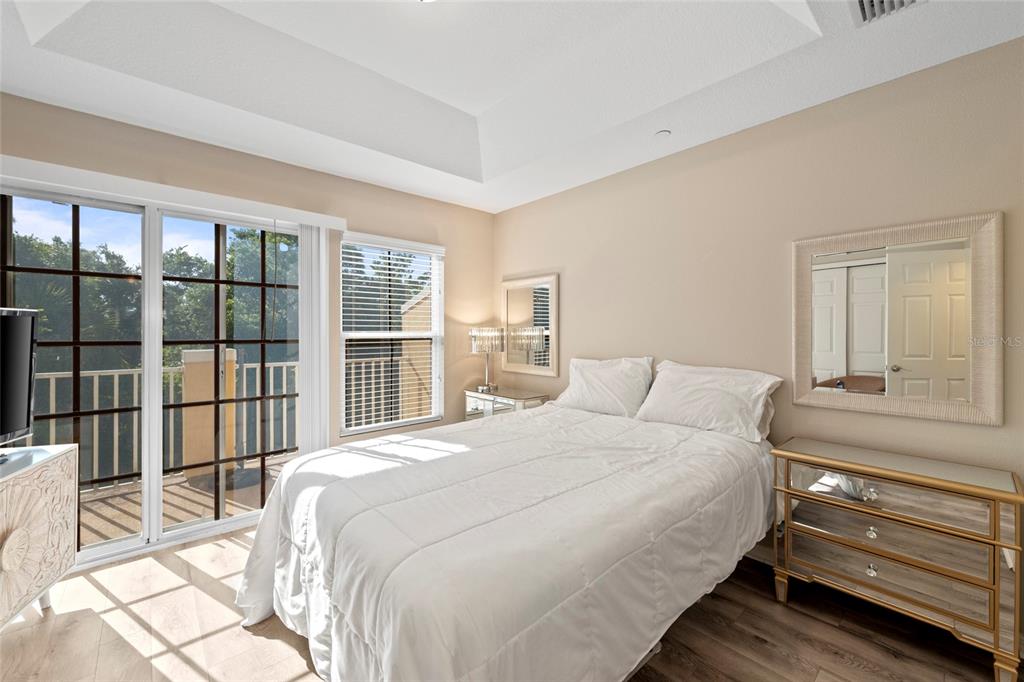 8825 White Sage Loop Lakewood Ranch, FL 34202 - Photo 18 of 33 a bedroom with a bed and a large window
