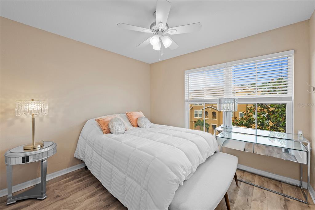 8825 White Sage Loop Lakewood Ranch, FL 34202 - Photo 26 of 33 a bedroom with a large bed and a large window