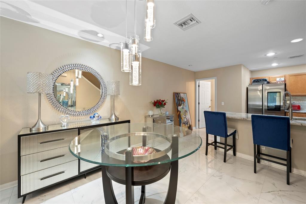 8825 White Sage Loop Lakewood Ranch, FL 34202 - Photo 8 of 33 a living room with furniture a mirror and a table