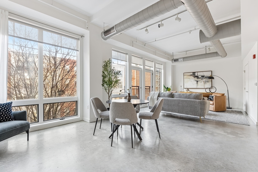 139 East Berkeley Street, Unit 402R Boston, MA 02118 - Photo 4 of 17 a view of a dining room with furniture window and outside view