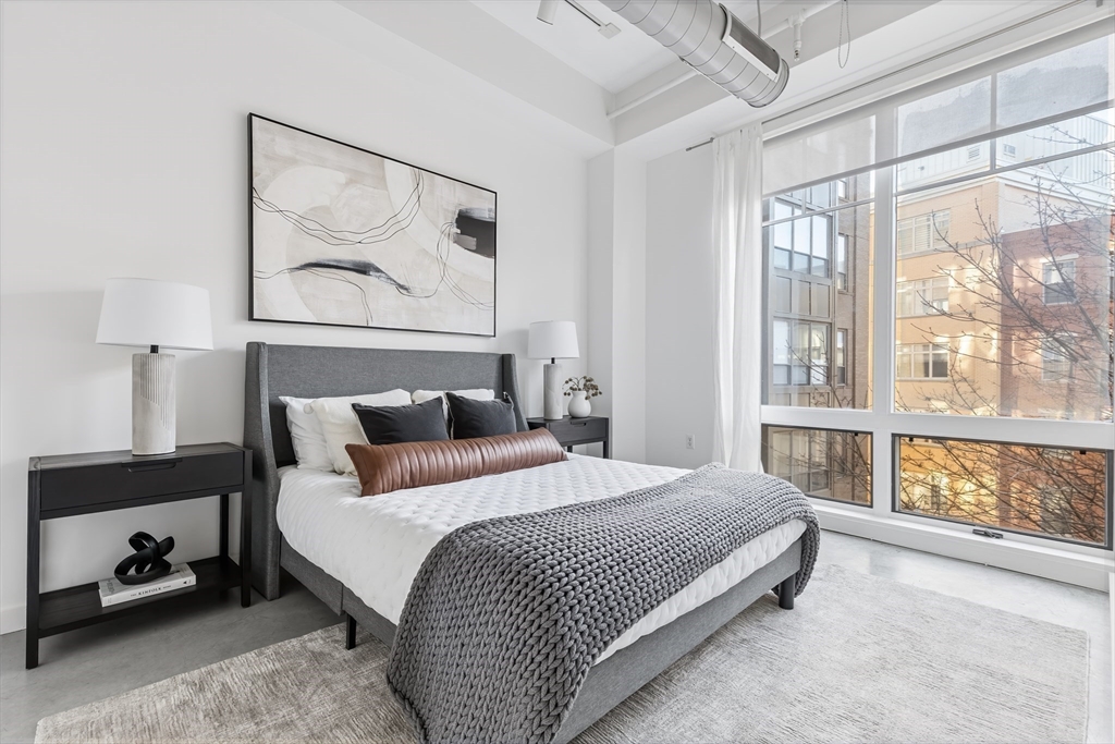 139 East Berkeley Street, Unit 402R Boston, MA 02118 - Photo 9 of 17 a bedroom with a bed and a large window with the outer view
