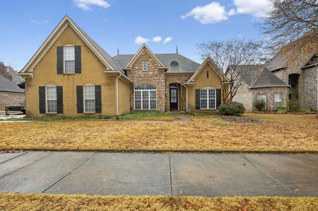 a front view of a house with a yard