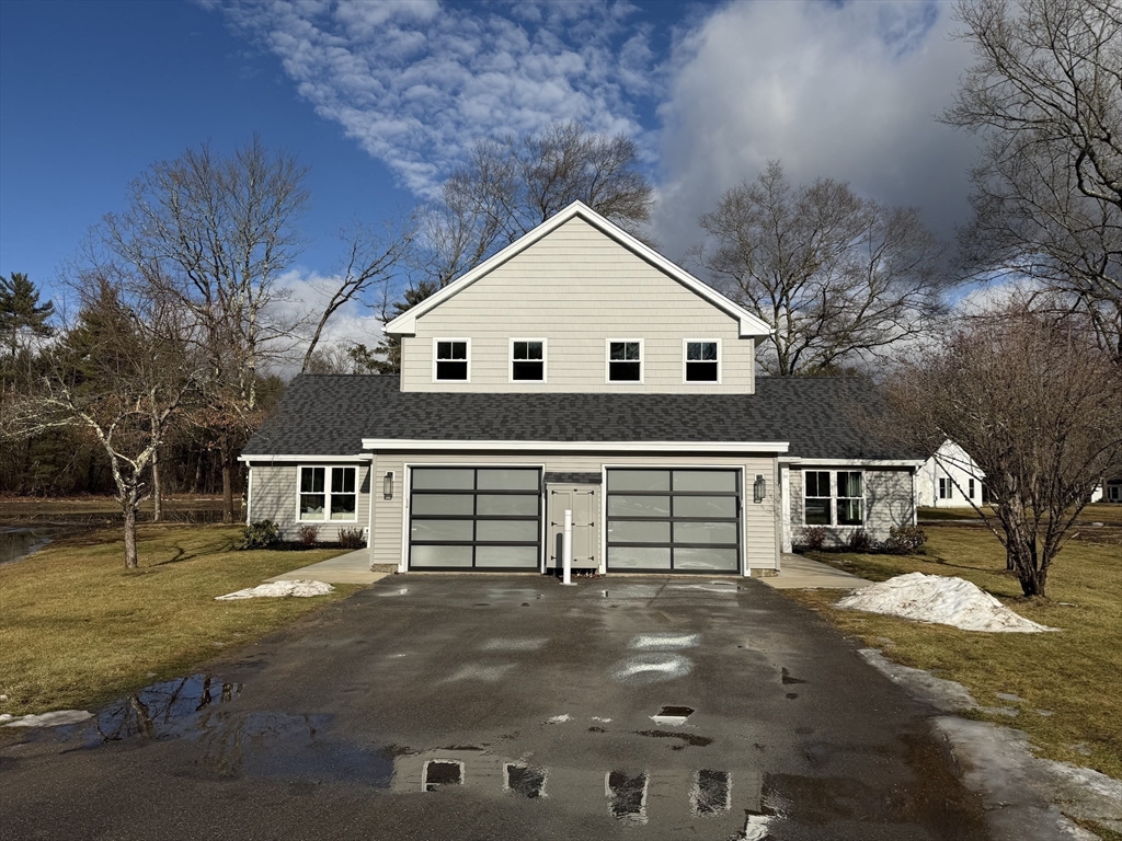 32 Barracks Road, Unit 32 Hudson, MA 01749 - Photo 2 of 16 a view of a white house with a yard and large trees