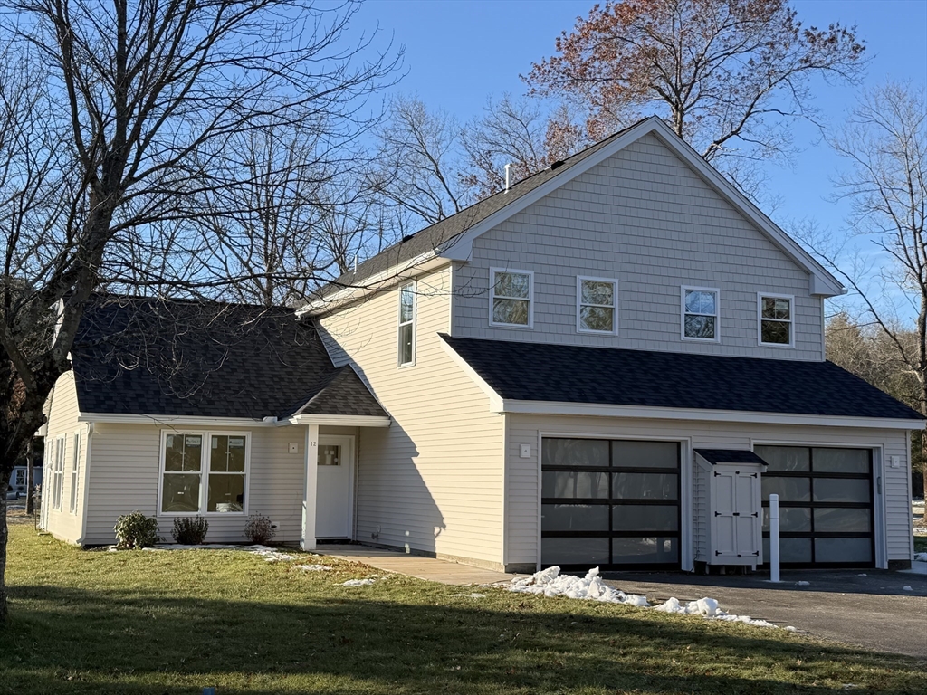 32 Barracks Road, Unit 32 Hudson, MA 01749 - Photo 3 of 16 a front view of a house with a yard