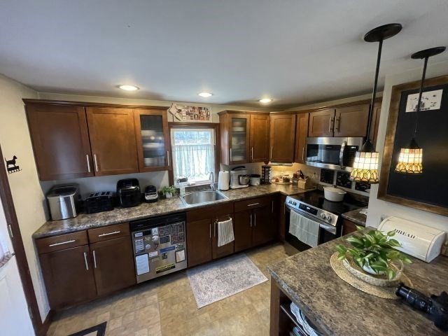 12 Hendricks Street Avon, MA 02322 - Photo 11 of 19 a kitchen with stainless steel appliances granite countertop sink stove top oven and cabinets