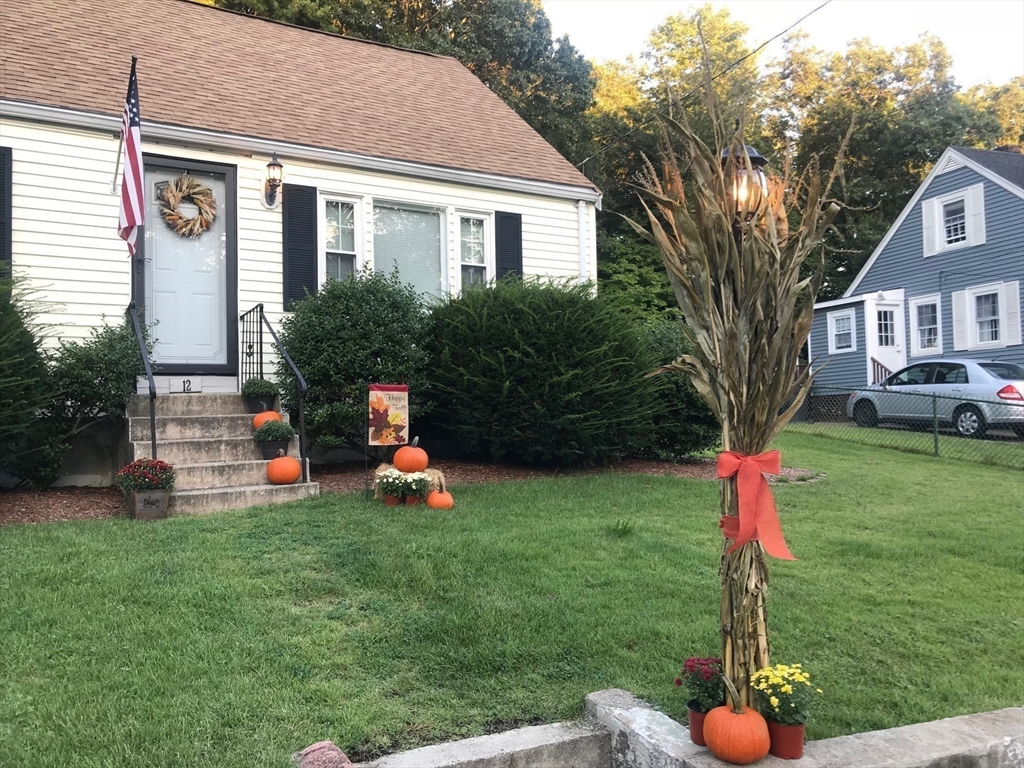 12 Hendricks Street Avon, MA 02322 - Photo 6 of 19 a front view of a house with a yard and trees