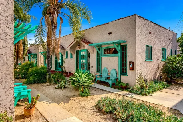 a view of a white house with a yard