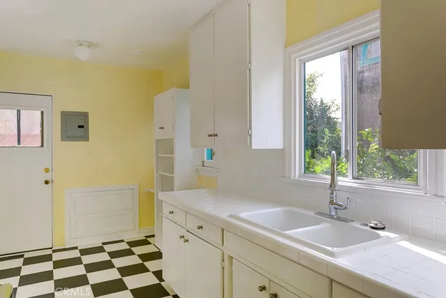 a spacious bathroom with a shower sink and mirror