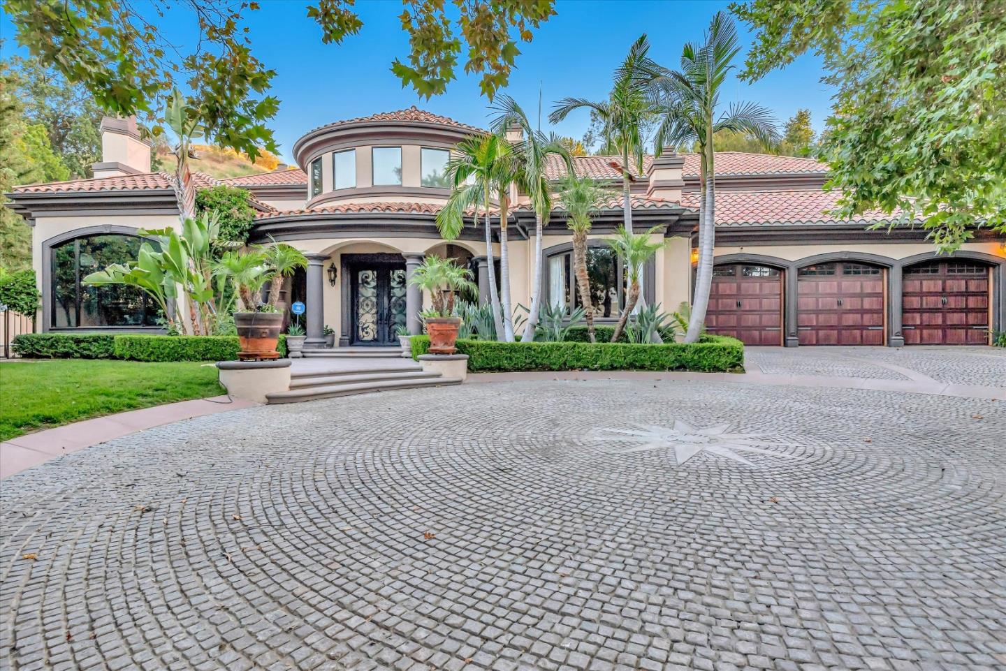 a front view of a building with a garden