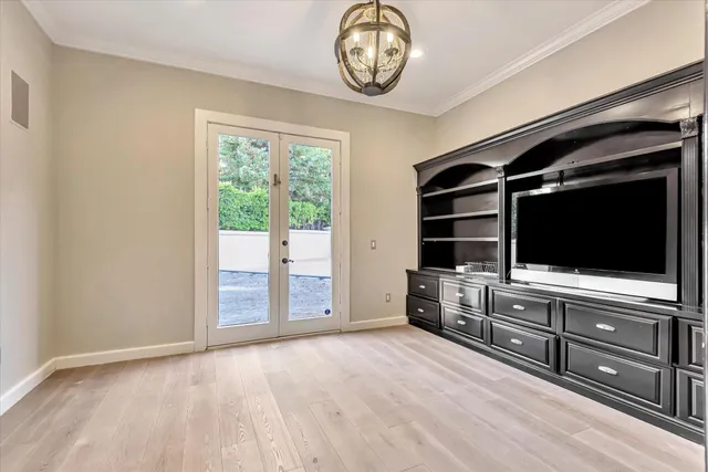 a view of room with cabinet flat screen tv and windows