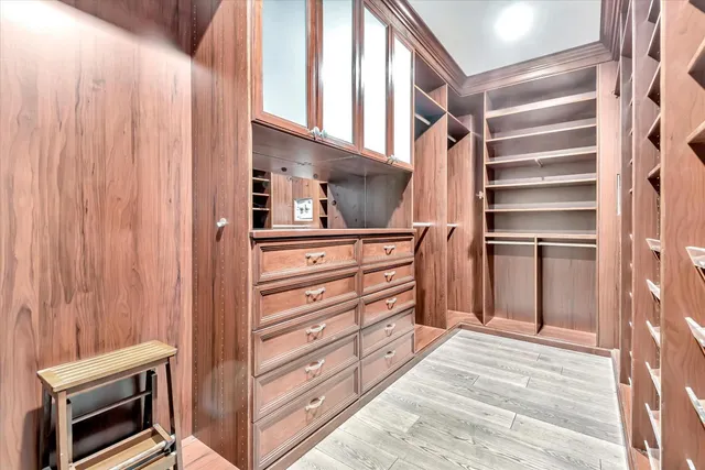 a view of walk in closet and bedroom