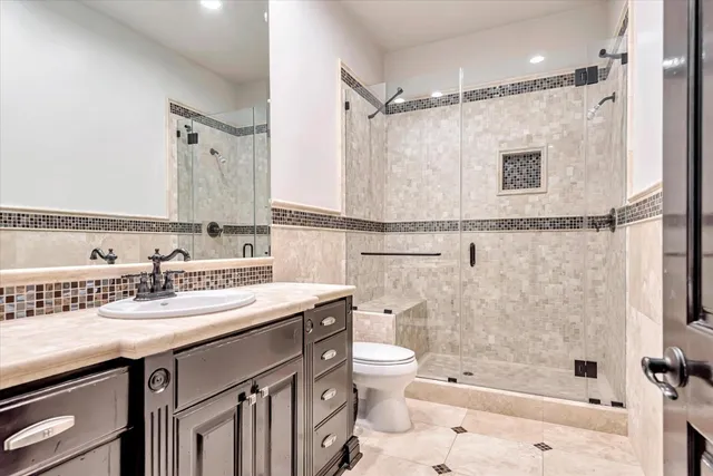 a bathroom with a sink double vanity mirror and a shower