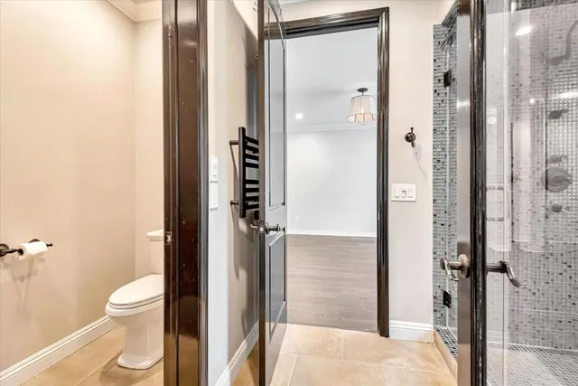 a bathroom with a toilet and a shower
