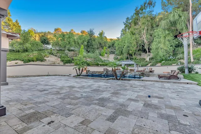 a view of backyard with outdoor seating and green space