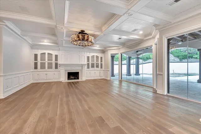 a view of a livingroom with wooden floor and a fireplace