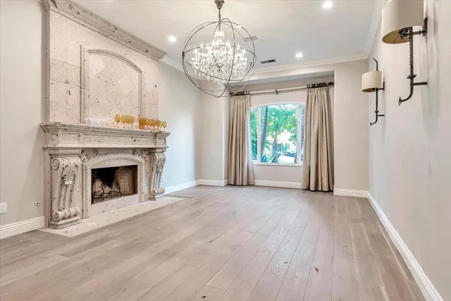 a view of an empty room with a fireplace and a window