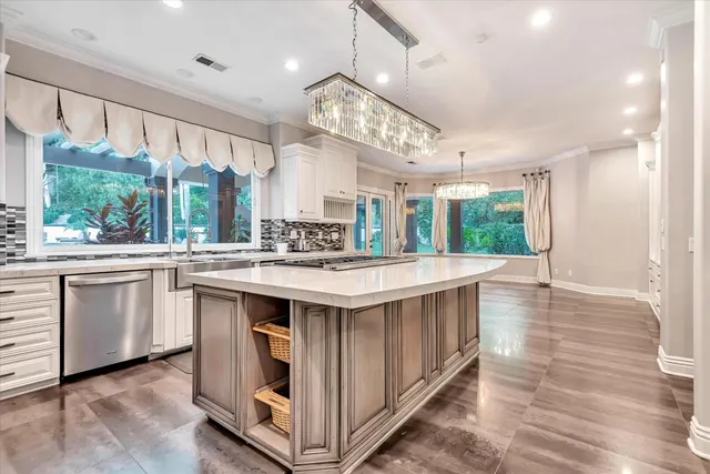 a kitchen with kitchen island granite countertop a stove and a sink